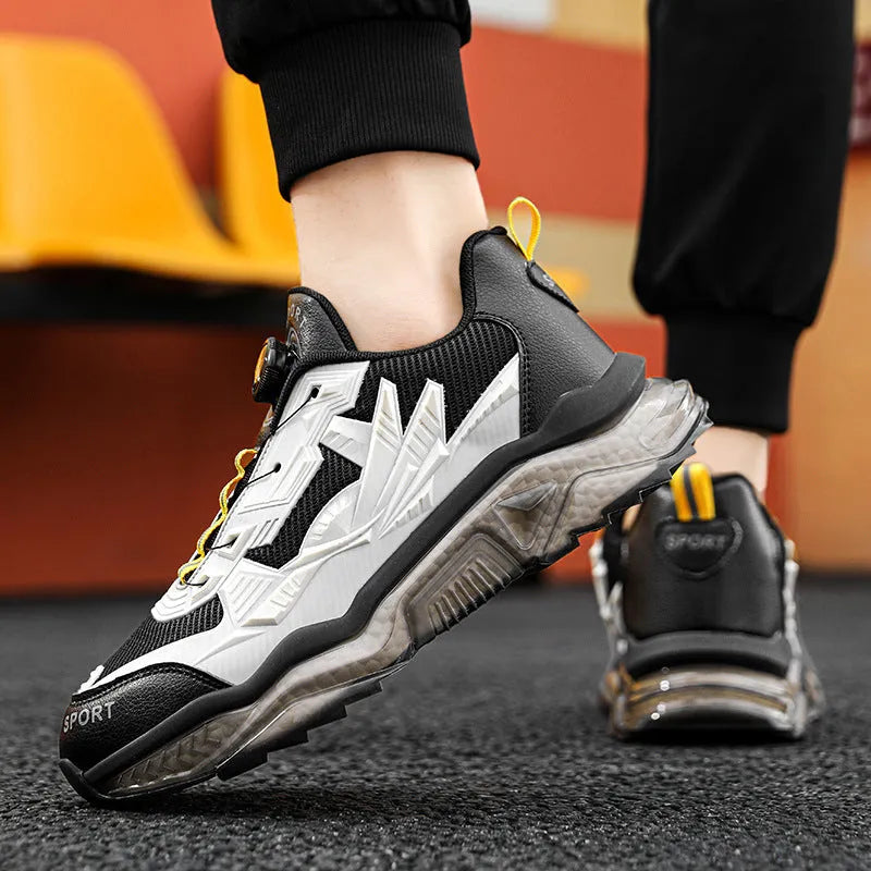 Men's black casual sneakers with rotating button closure and mesh upper on rubber sole.