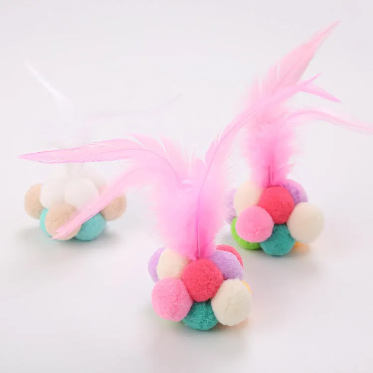 Cat toy feather wand with colourful pink and blue white feathers and a bouncy ball.