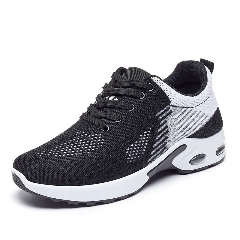 Women's pink Flyknit casual running shoes with mesh lining and flat PVC sole on a white background.