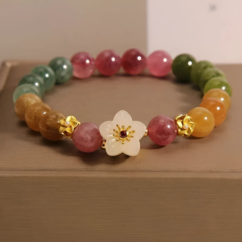 Natural tourmaline bracelet with flower and Fu charms on silver-tone electroplated brass.