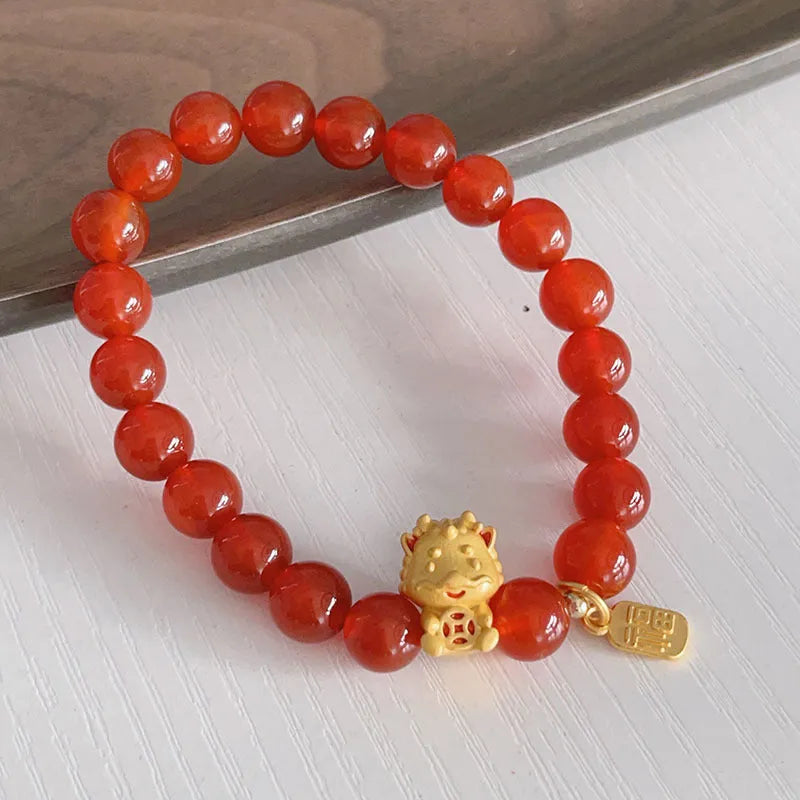 Women's red agate bracelet with Chinese dragon design, a handcrafted gift for Bamboo Festival.