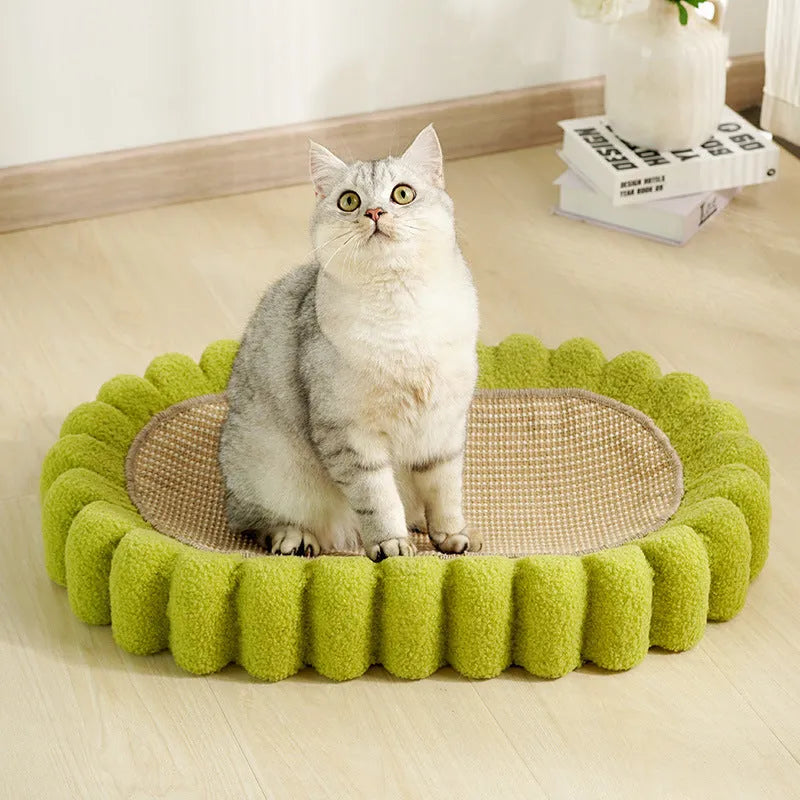 Green oval-shaped cat scratcher pad with sisal surface serving as a scratching area and cat bed.