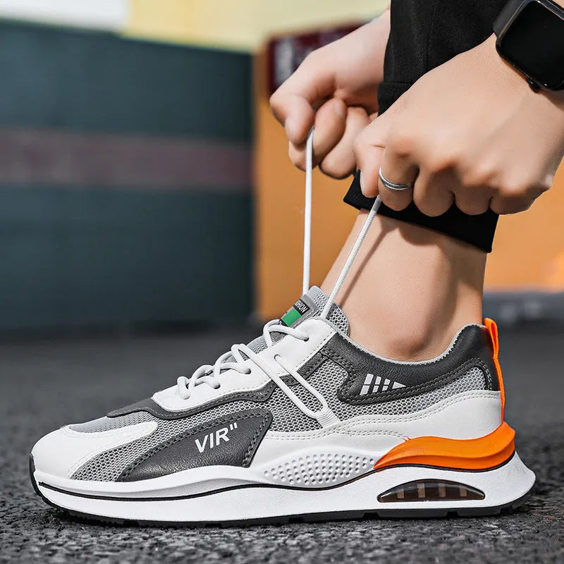 Men's gray mesh running shoes with round toe and middle top height on white background