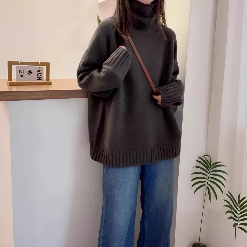 Women's loose thick turtleneck sweater with a curled pile collar in a solid colour.