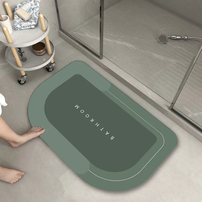 Blue oval blended fabric bathroom floor mat placed on tiled floor.
