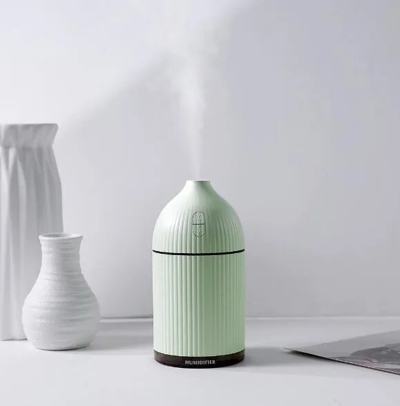 White ultrasonic aromatherapy diffuser humidifier with LED light and 300ml water bottle.