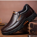 A pair of black and brown business casual leather shoes with a rubber sole, shown from the side.