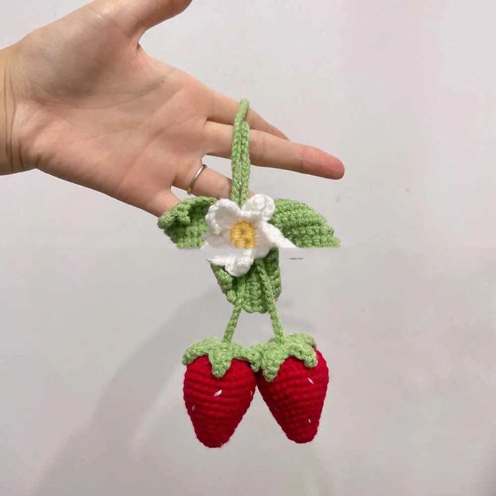 Handmade woven strawberry pendant decoration for car or keychain with lily of the valley hook.
