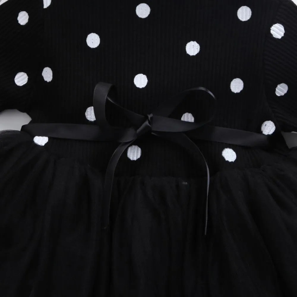 Baby girl wearing a long sleeve white lace tutu dress for a birthday party