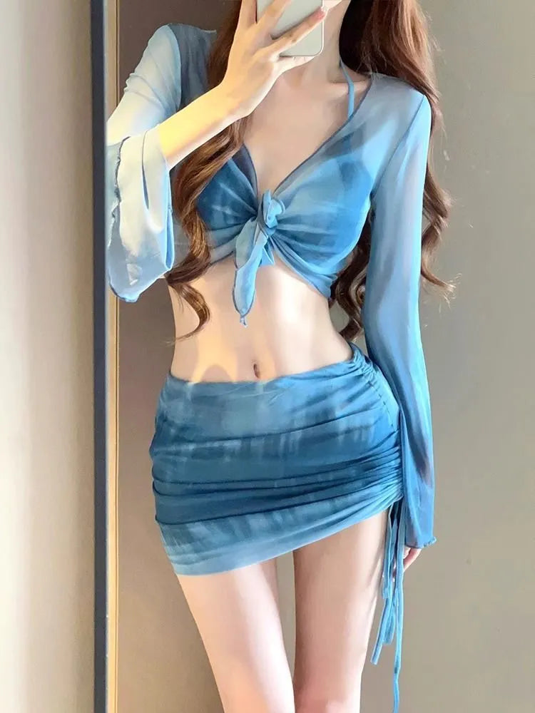 Women's blue high-waisted bikini four-piece swimsuit set showing shirt, bra, underwear and skirt components