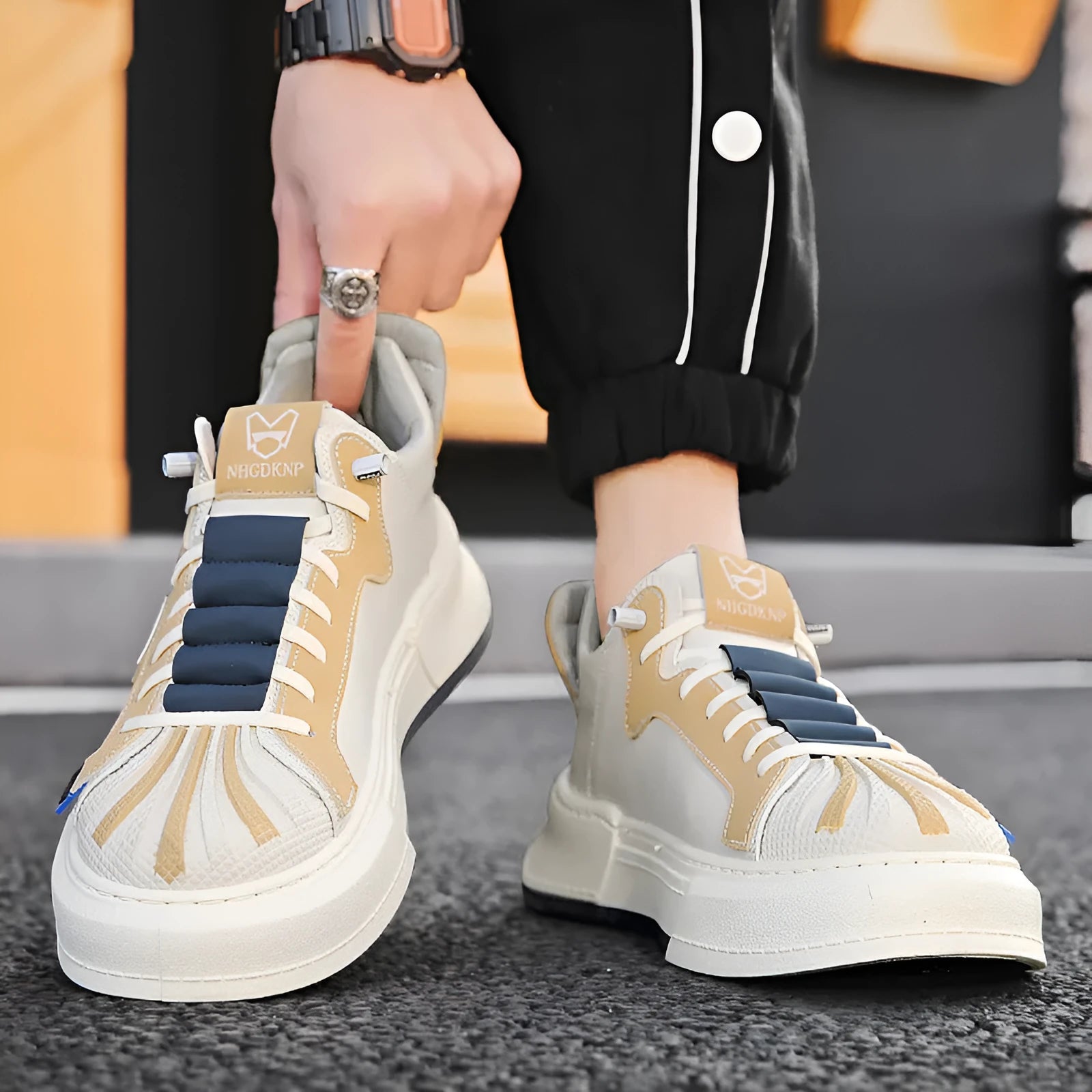 Men's beige casual low-top sneakers with elastic band and leather stitch detail on microfiber upper.