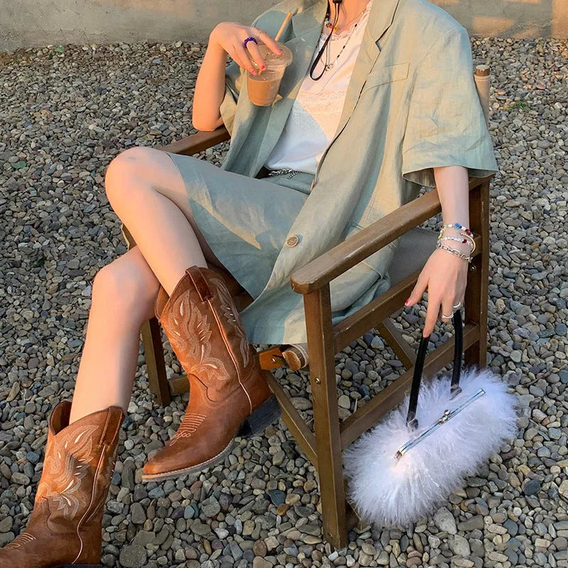 Brown women's embroidered leather Martin boots with a low square heel and mid-calf design.