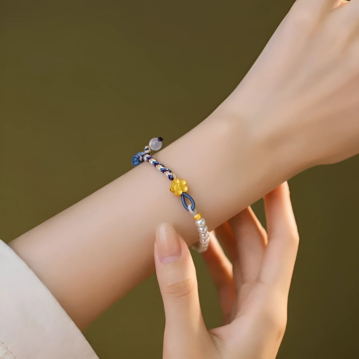 Peach coloured cord carrying strap with electroplated sterling silver chalcedony bead and Chinese flower weaving design
