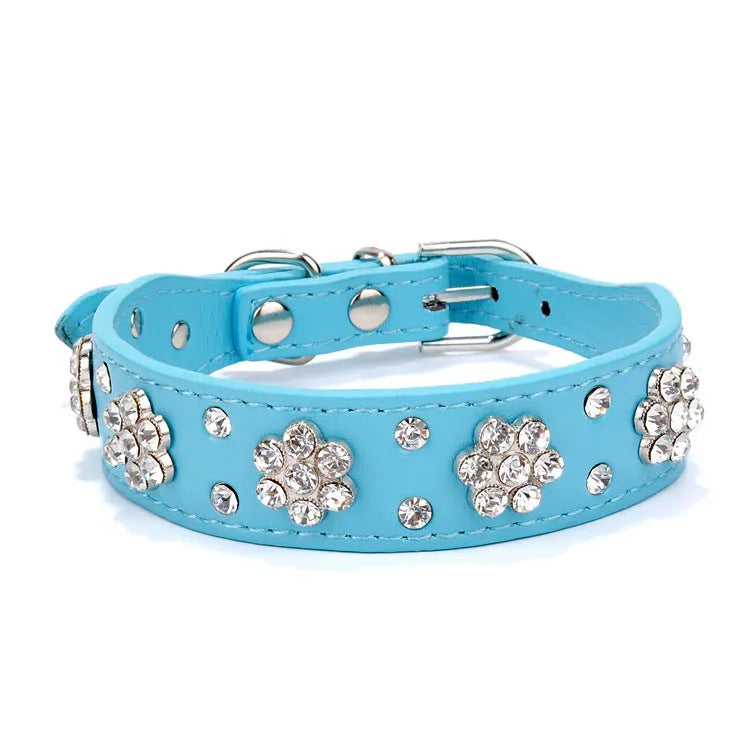 Soft black PU leather dog collar with a sparkling rhinestone flower pattern and silver metal studs, showing the adjustable eyelets and D-ring.