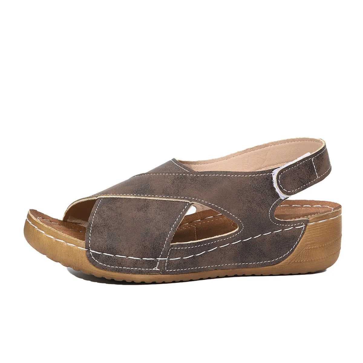 Women's brown Roman sandals with Velcro strap and platform wedge sole on a white background.