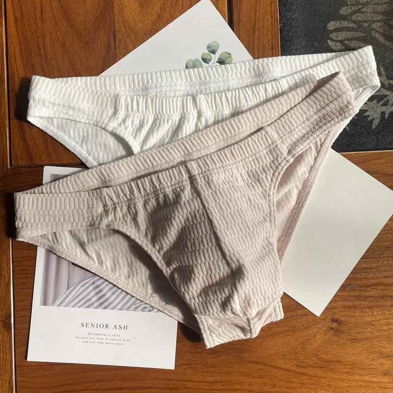 Men's solid colour cotton triangle briefs with a mid waist design on a white background.