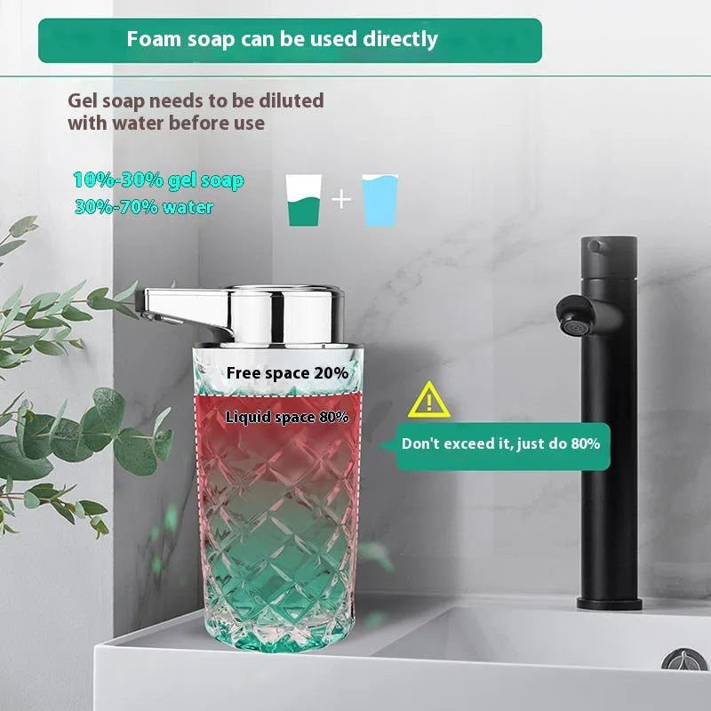 Silver automatic sensor soap dispenser with USB-C charging port on a bathroom counter.