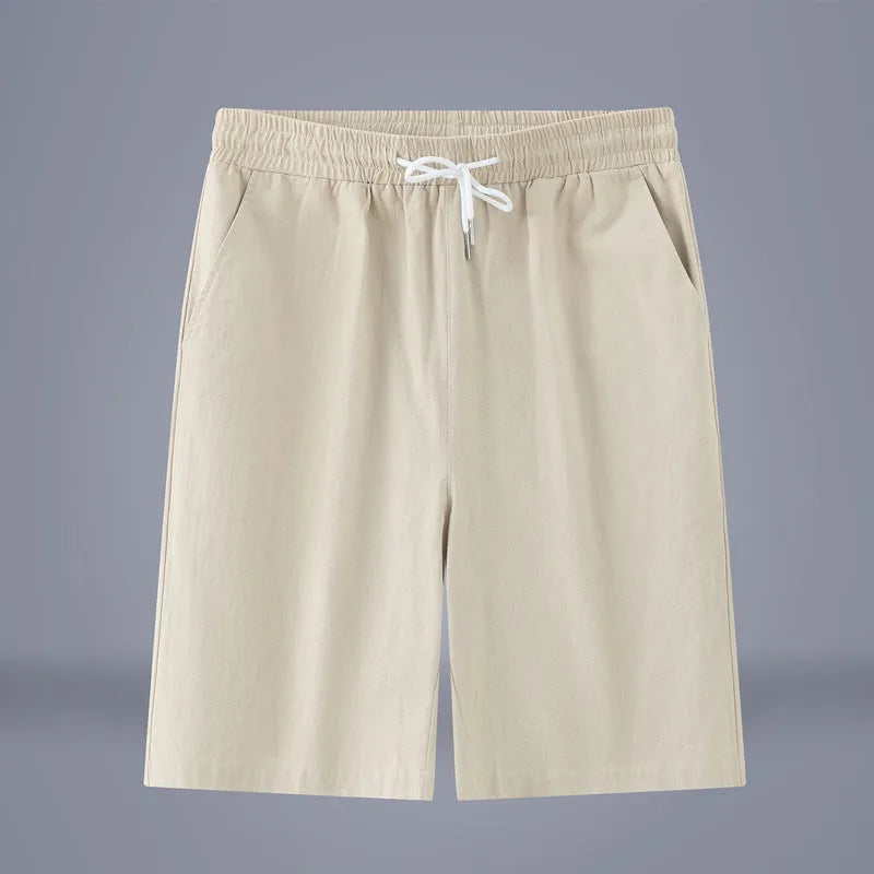 Man wearing solid colour cotton linen cropped trousers with a drawstring waist in a casual setting.
