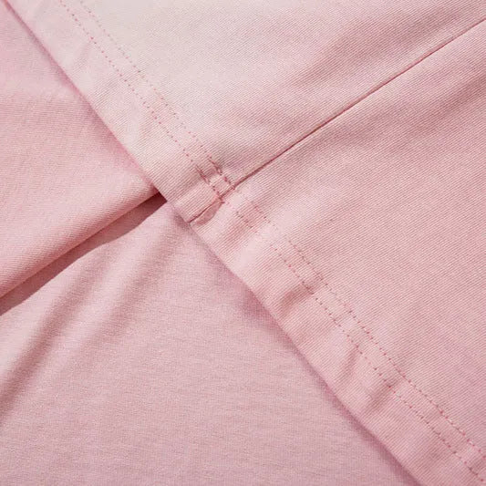 Women's long sleeve cotton pullover top with loose fit and drop-shoulder sleeves in dark grey or pink