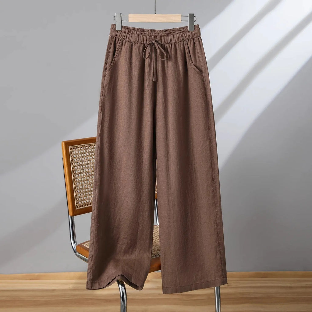 Women's apricot straight-leg casual trousers with a drawstring elasticated waist laid flat.