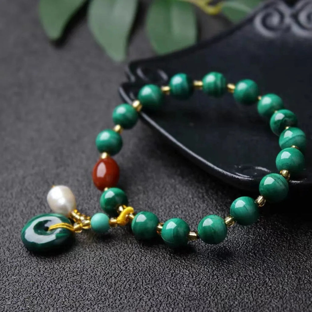 Natural malachite and southern red agate bracelet with 7-8mm round barrel beads on wrist