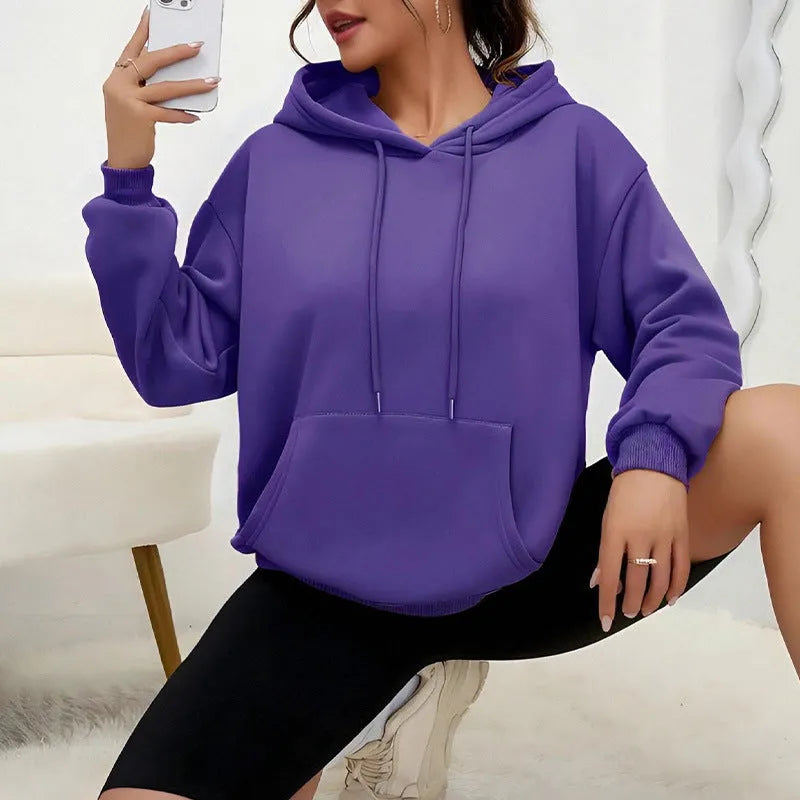 Women's loose drawstring pocket sweatshirt in polyester fabric showing side pockets and long sleeves