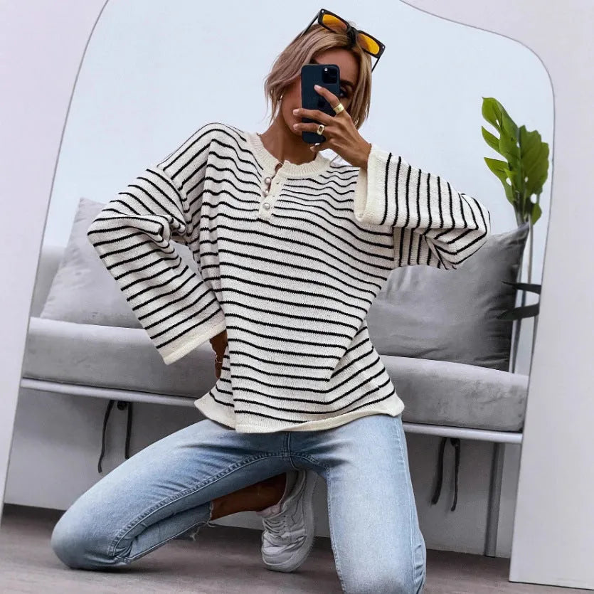 Black striped women's casual top with drop shoulders and button detail