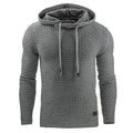 Men's black hooded sweatshirt made from cotton and polyester blend fabric on a grey background.