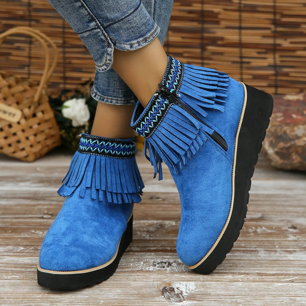 Women's black suede wedge ankle boot with side zip, tassel, and thick rubber sole.