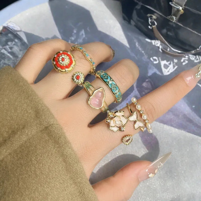Adjustable copper ring featuring a gourd, flower, and bow design with zircon inlay in New Chinese style.