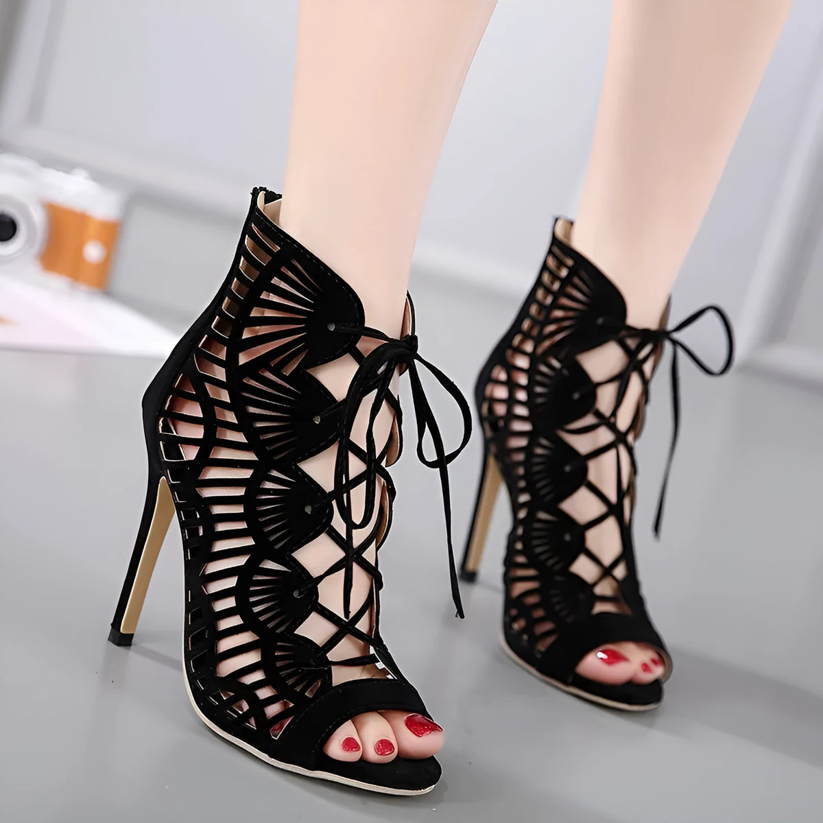Black suede lace high heels with fish mouth toe, stiletto heel above 8 cm, and hollow detail.