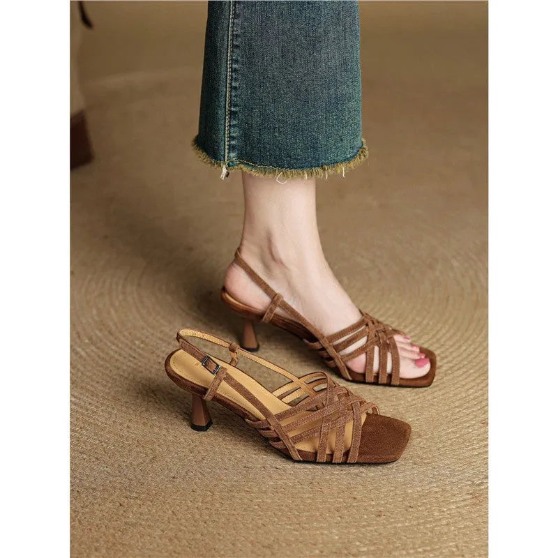 Retro-style women's sandals with thin cross straps, ankle buckle, and a mid heel.