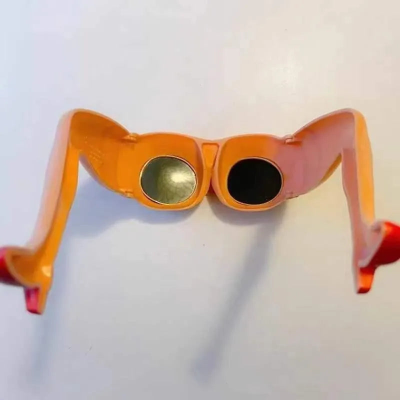 Orange plastic novelty sunglasses with a leg hip frame design on a white background.