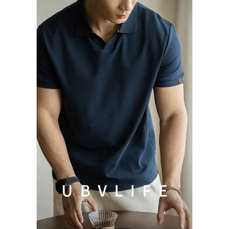 Man's American-style blue cotton blend short-sleeved polo shirt on a hanger.