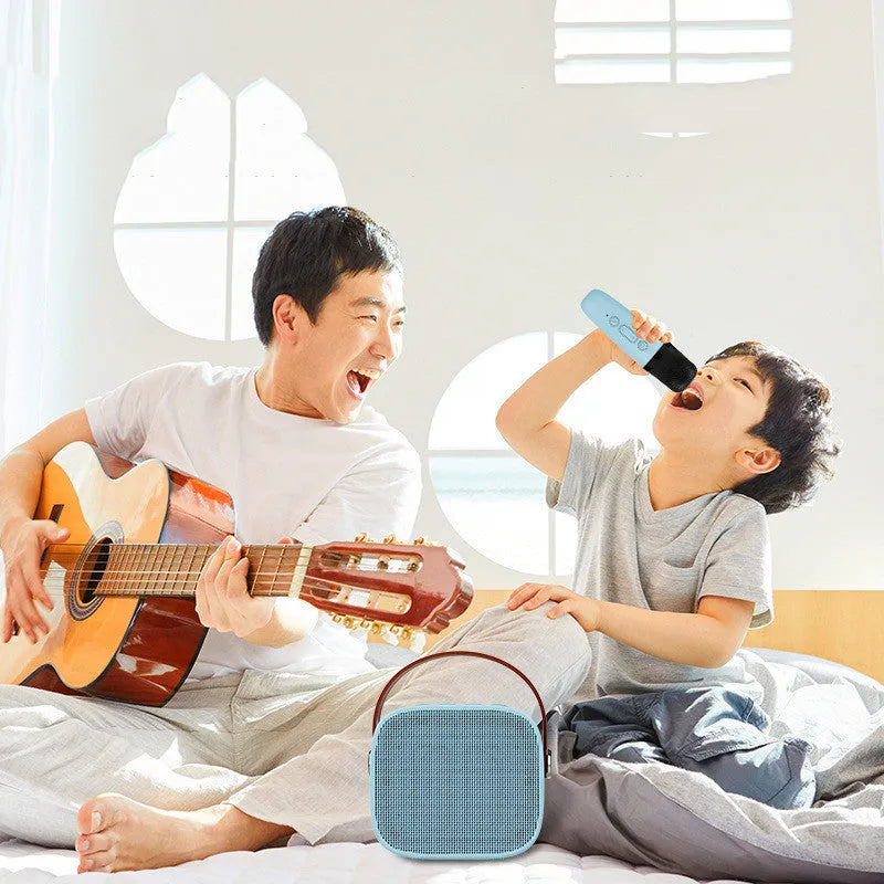 Small white portable Bluetooth speaker with built-in microphone on a table.
