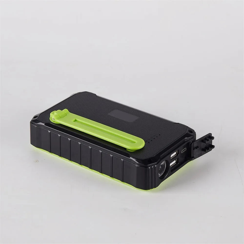 Orange and green solar hand power bank with 12000mAh capacity showing dual USB ports and hand crank