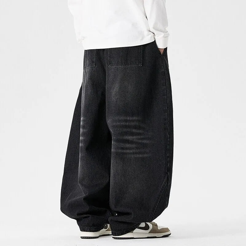 Men's plus size baggy jeans in dark blue denim with a straight leg opening and low waist.