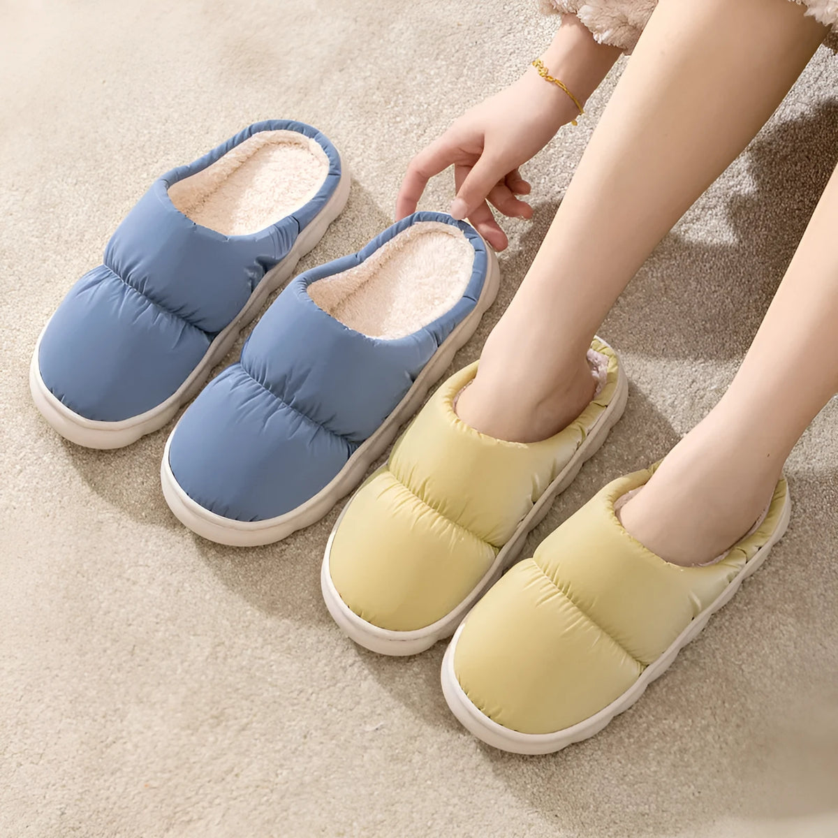 Blue winter indoor slippers with thick rubber sole and plush lining, shown on a hard floor.