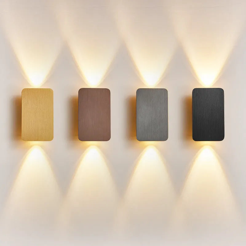 Minimalist modern LED wall lamp in black finish mounted on a wall.