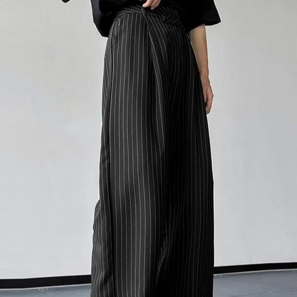 Men's black vertical striped pleated casual trousers showing elastic waistband and leg detail