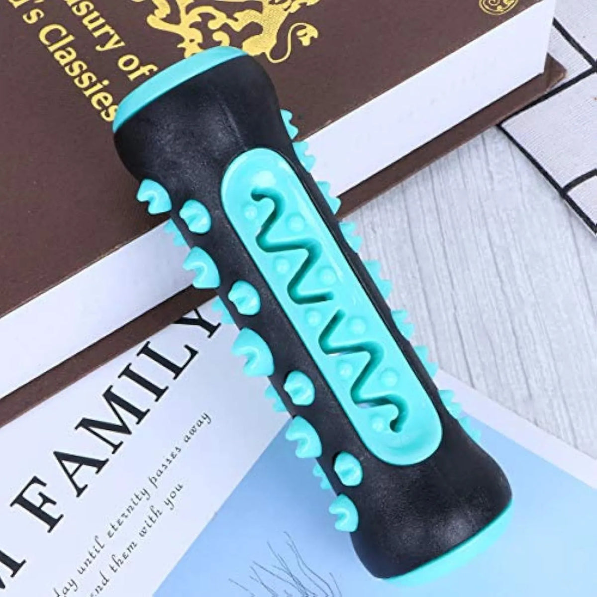 Natural rubber dog dental chew toy in blue, shaped like a toothbrush with cleaning ridges.