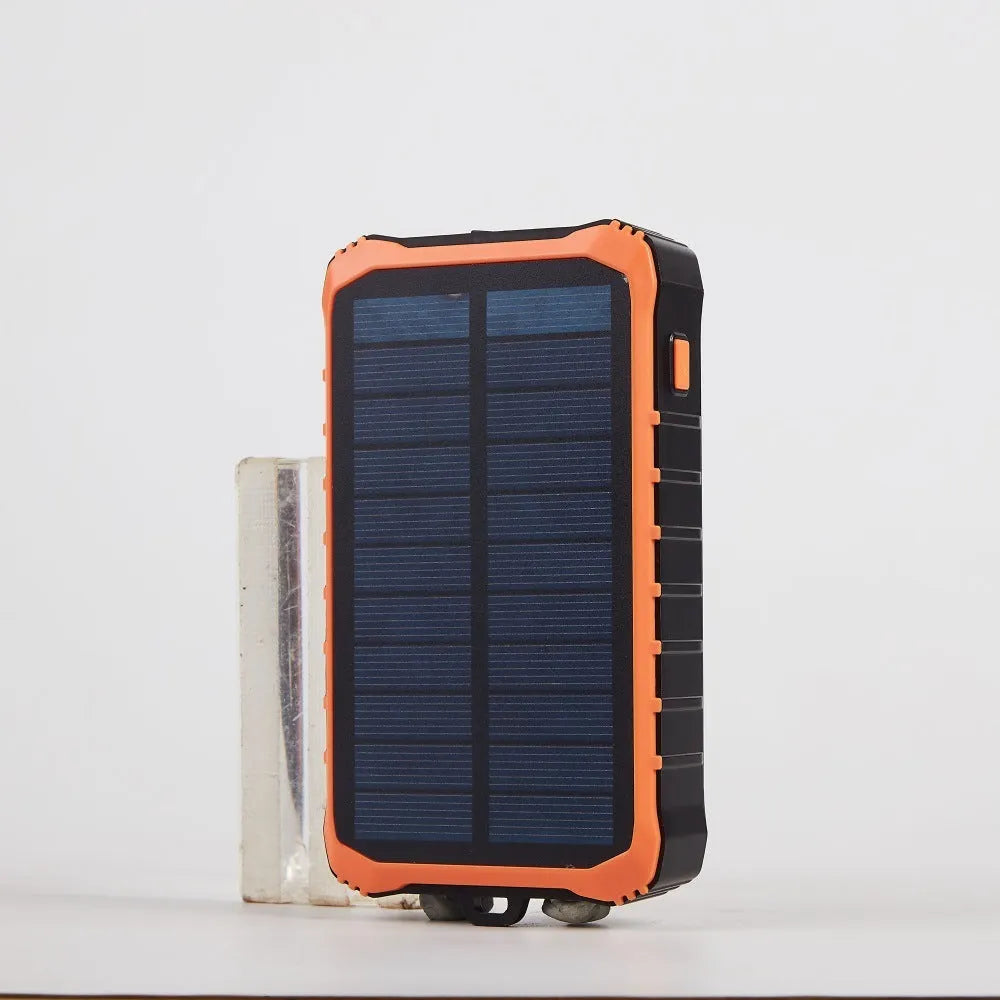 Orange and green solar hand power bank with 12000mAh capacity showing dual USB ports and hand crank