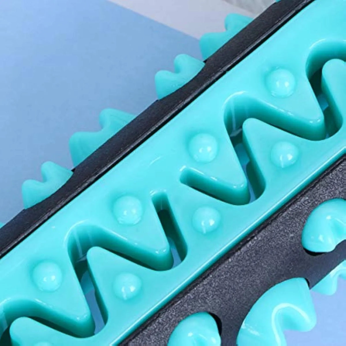 Natural rubber dog dental chew toy in blue, shaped like a toothbrush with cleaning ridges.