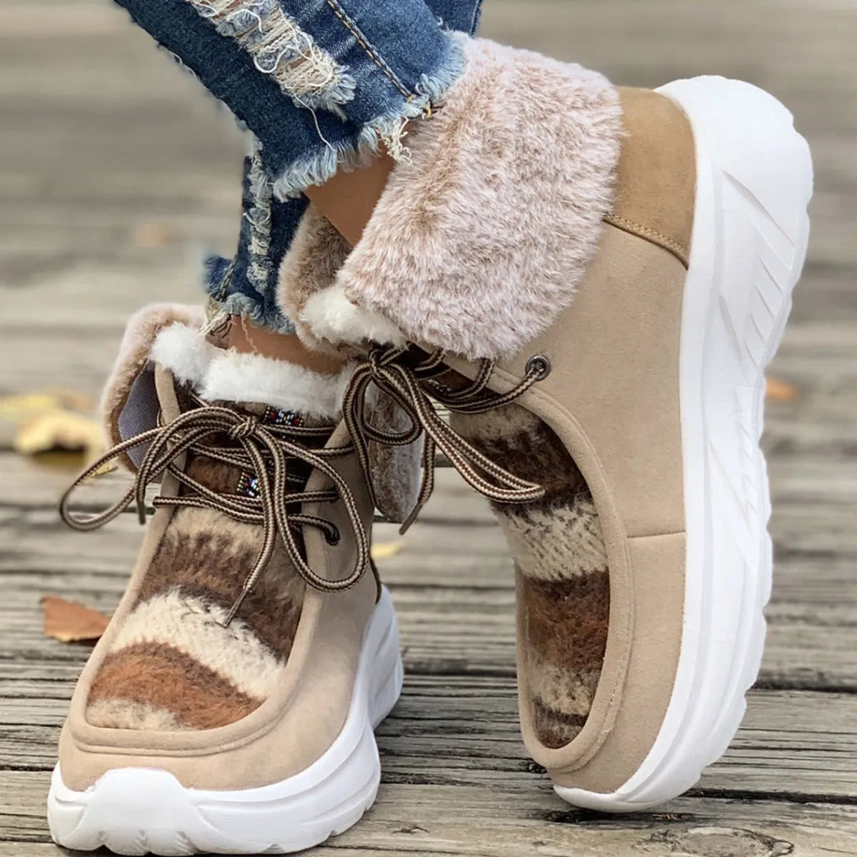 Beige women's lace-up suede snow boots with plush lining and a thick rubber sole.