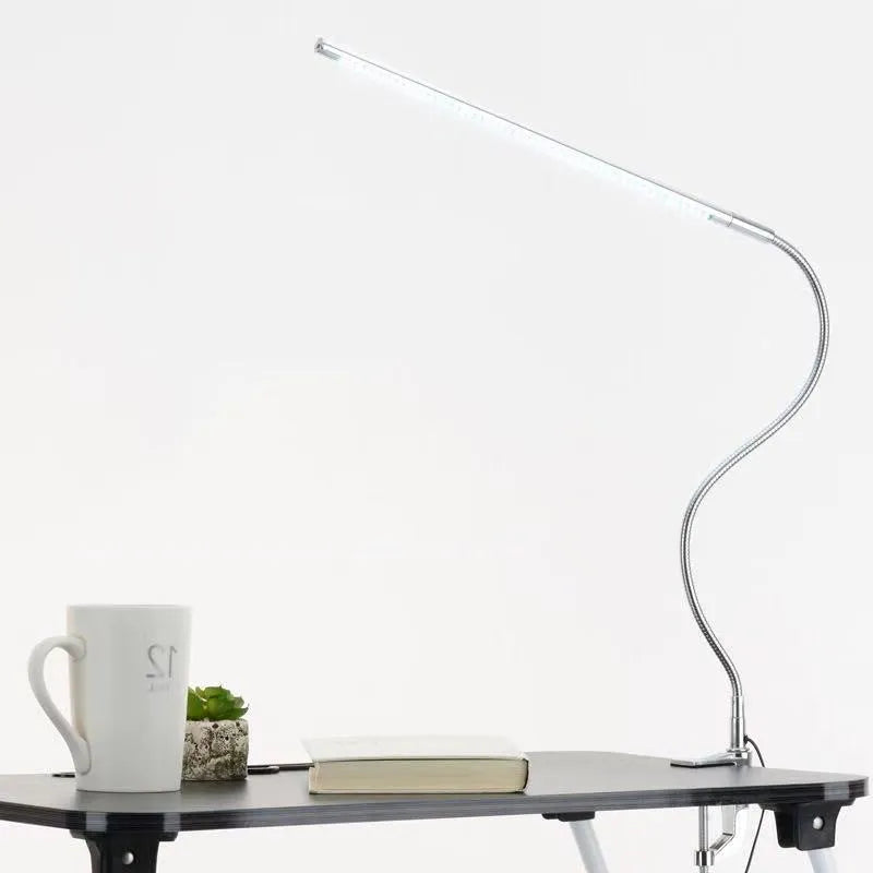 Silver LED clip-on table lamp with long adjustable arm for nail lighting and detailed work
