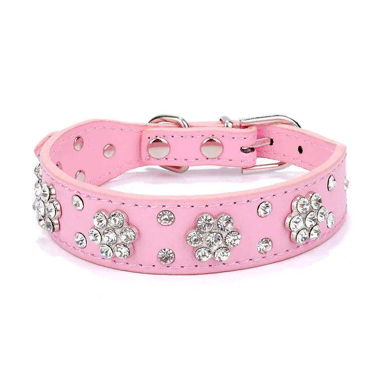 Soft black PU leather dog collar with a sparkling rhinestone flower pattern and silver metal studs, showing the adjustable eyelets and D-ring.