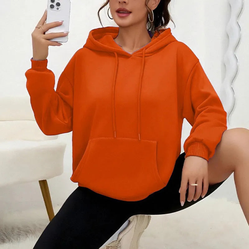Women's loose drawstring pocket sweatshirt in polyester fabric showing side pockets and long sleeves