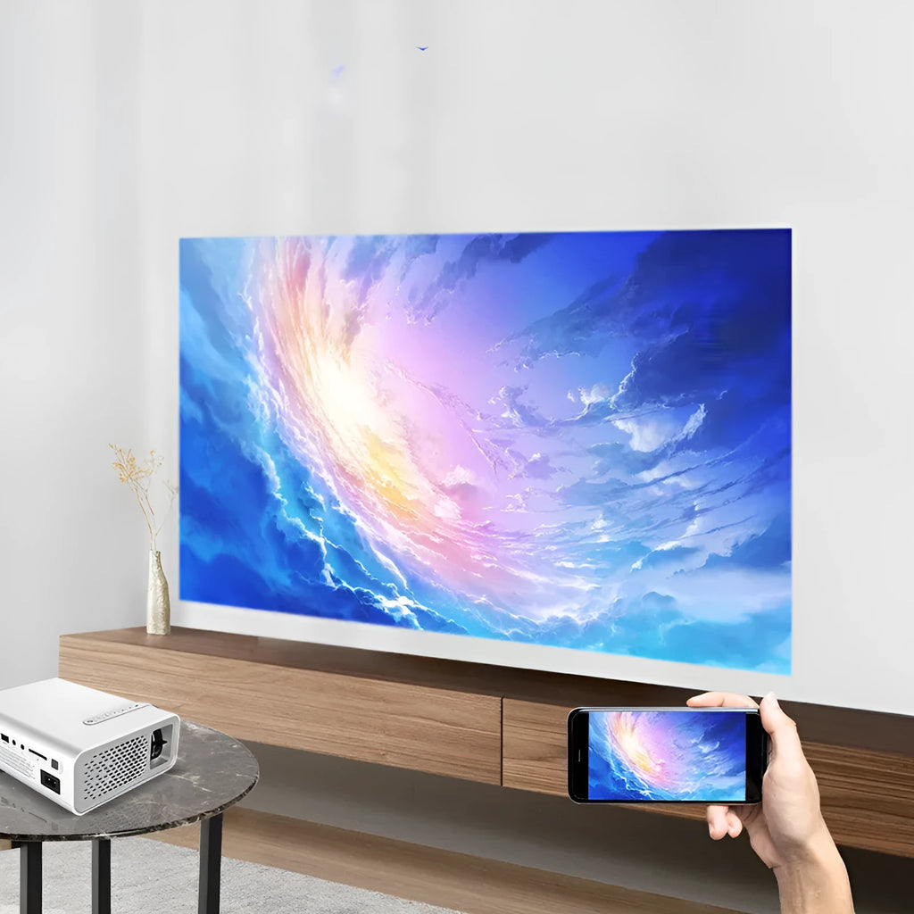 YG530 black and white mini portable LED projector with wireless mobile phone connectivity on a table.