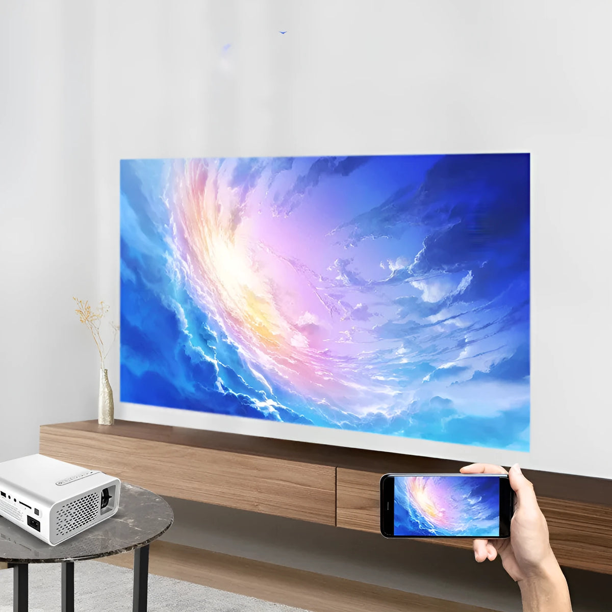 YG530 black and white mini portable LED projector with wireless mobile phone connectivity on a table.