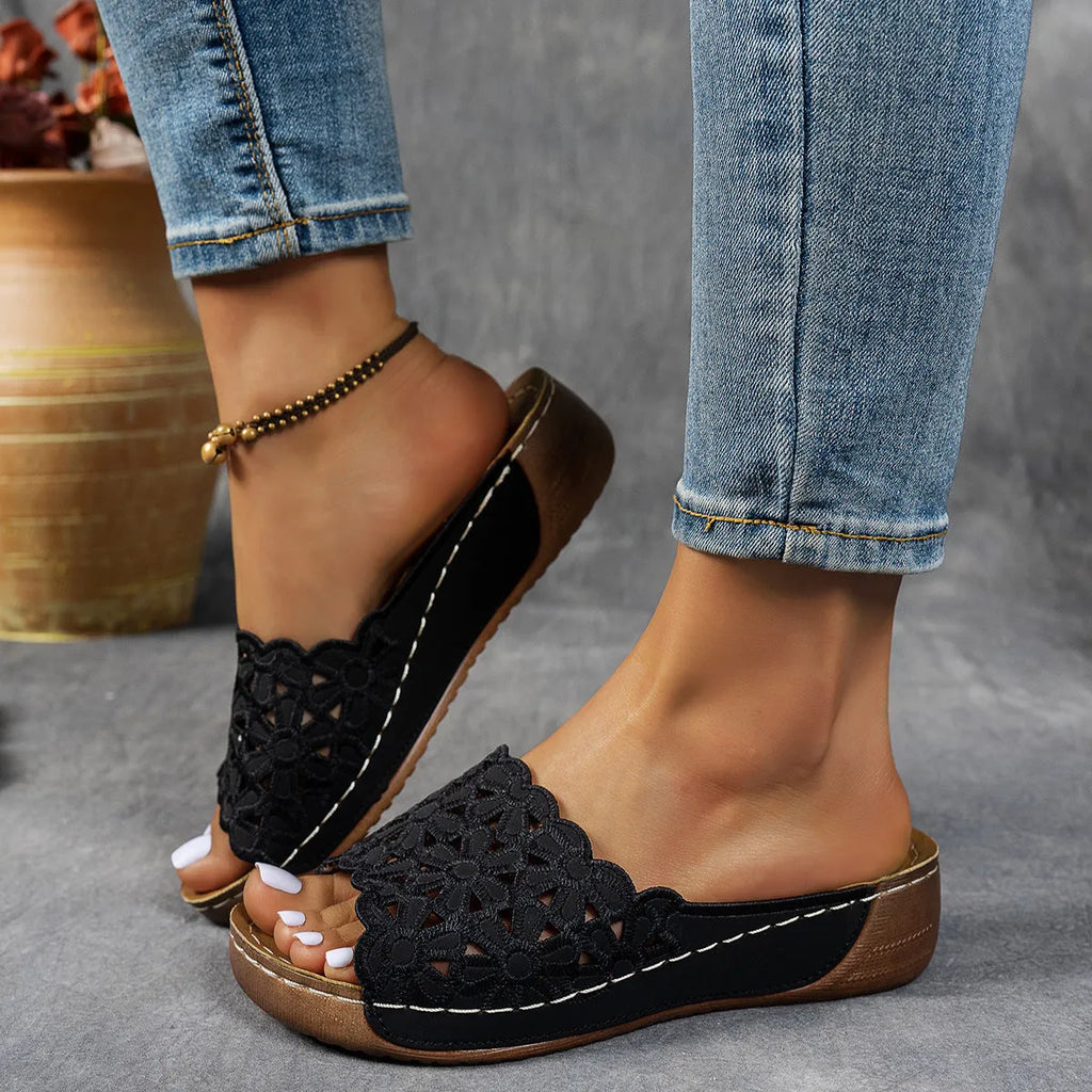 Women's floral cutout wedge beach slippers in black, blue, khaki, or light brown with PVC upper and rubber sole